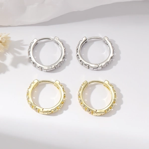 Minimalist micro-pave zircon hoop earrings set in gold and silver finish with crystal stones