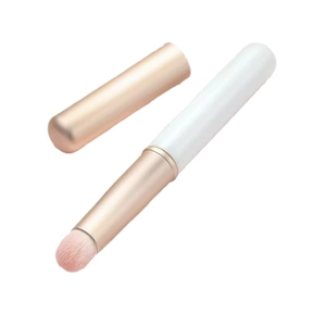 Portable silicone lip brush with round head and rose gold lid for lipstick blending