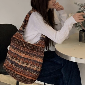 Detail of the multi-colored striped knit tote bag with soft plush texture and grid lining