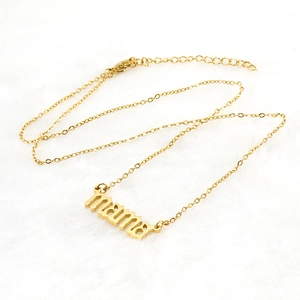 Gold stainless steel necklace with mama letter pendant on white plush background