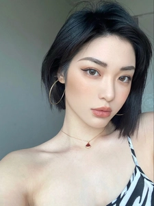 Fashionable golden hoop earrings and red fan-shaped pendant necklace on model