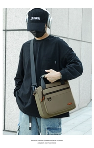 Detail showing khaki nylon messenger bag with front zipper pocket and sturdy top handles
