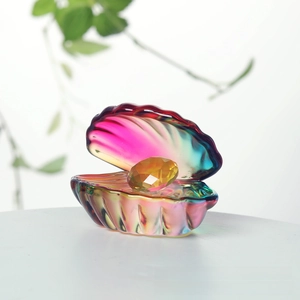 Macro shot of iridescent rainbow crystal shell ornament with faceted yellow pearl detail