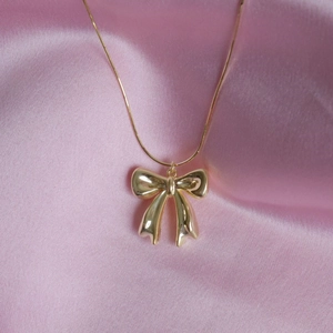 Collana con ciondolo a fiocco dorato su seta rosa, elegante catena serpente per donna