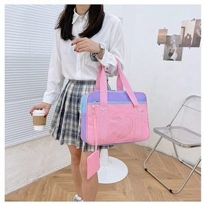 Detail of pink and purple JK uniform bag with heart-shaped window for pins
