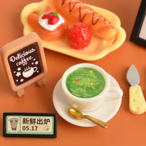 Miniature Christmas coffee set with latte art cup and dessert tray on warm background