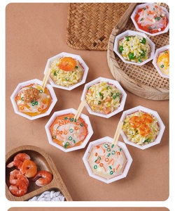 Macro shot of miniature food bowl keychains featuring realistic shrimp rice and chopsticks