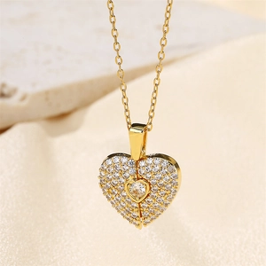 Macro view of gold heart pendant necklace featuring micro-set sparkling zircon crystals