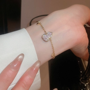 Detail of 18k gold plated gourd bracelet with zircon inlay on a model wrist