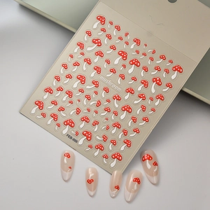 5D embossed nail art stickers featuring red and white mushroom patterns on clear sheets