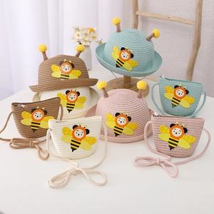 Detail view of children's cartoon bee straw hat and matching bag set in multiple colors