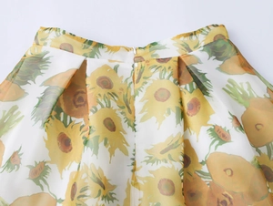 Detail of sunflower print organza skirt showing pleated waist and invisible zipper