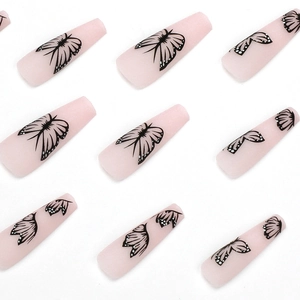 Long ballerina press-on nails in matte nude pink with detailed black butterfly patterns