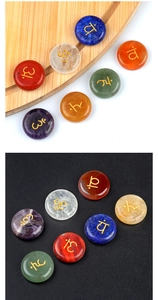 Macro detail of seven chakras natural crystal stones with engraved golden yoga symbols