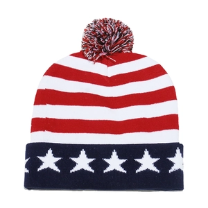 Close-up of the red and white striped knit texture and pom-pom detail on the USA flag beanie