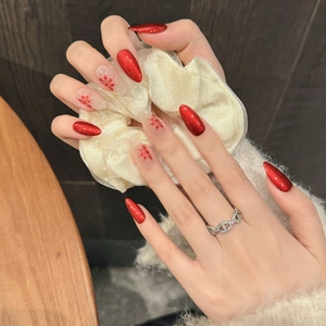 Red cat-eye handmade press-on nails with snowflake art and long almond shape design