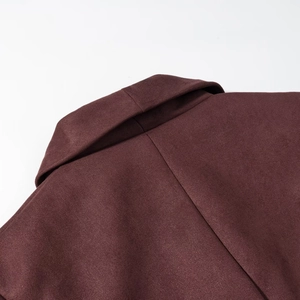 Detail of faux suede jacket showing high-quality stitching and rich dark burgundy texture