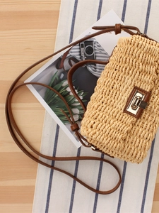 French vintage woven crossbody bag in beige straw with brown strap and gold metal lock