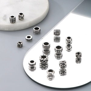 Detailed close-up of patterned titanium steel spacer beads for jewelry making