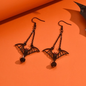 Gothic black bat earrings with bead drops for Halloween on a vibrant orange background