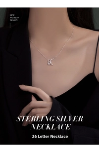 Close-up of S925 sterling silver letter K necklace with sparkling zircon on model
