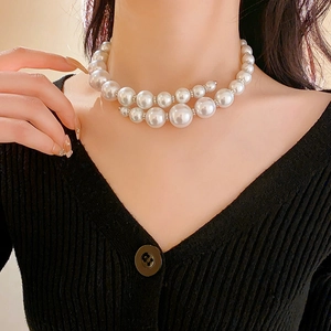 Close-up of double-layer white faux pearl choker with silver spacer beads on model