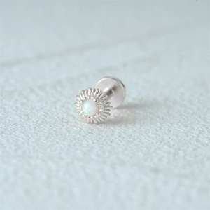 Macro shot of S925 silver sunflower stud with white opal and flat back threading
