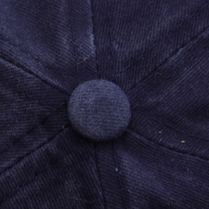 Detail of the navy blue cotton twill baseball cap crown and reinforced top button