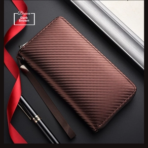 Close-up of carbon fiber texture on brown men's long wallet with metal zipper