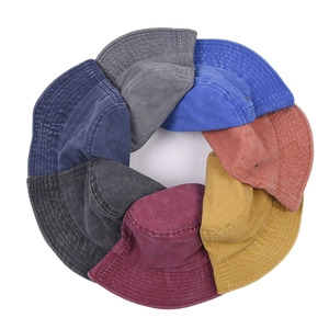 Detailed macro view of vintage washed cotton bucket hats with premium stitching and texture