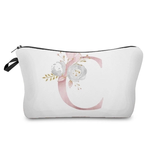 Close-up of elegant floral pink letter C print on a white canvas cosmetic bag