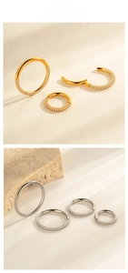 Detail view of titanium nose rings with inlaid zircon stones in silver and gold finish