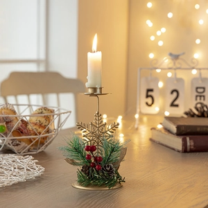 Golden Christmas snowflake candle holder with pine cones and red berries decor
