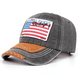 Detail of vintage American flag patch and suede brim on washed grey baseball cap