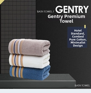 Macro detail of soft combed cotton towels in grey, white and navy with striped texture