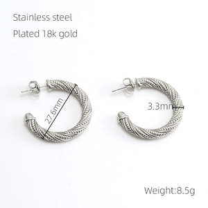 Detailed view of 18k gold plated twisted hoop earrings with 27.6mm diameter specs