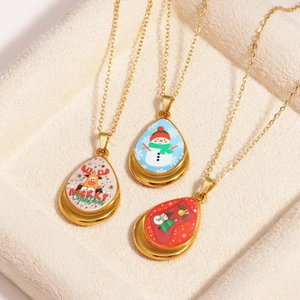 Three gold Christmas necklaces with reindeer, snowman and stocking water drop pendants