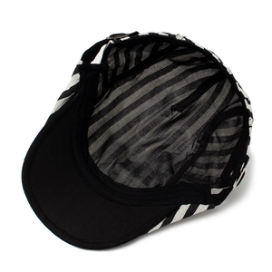 Internal view of a black and white striped linen newsboy cap with breathable lining