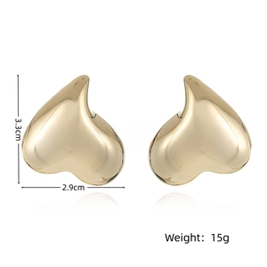 Detail view of 18k gold plated chunky heart stud earrings showing 3.3cm x 2.9cm dimensions