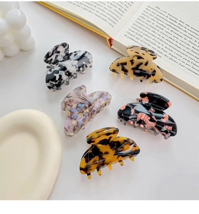 Detailed set of 5 acetate hair claws in various patterns like tortoiseshell and floral