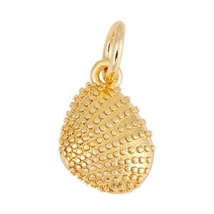 Macro detail of golden teardrop pendant with textured granular finish and metallic gloss