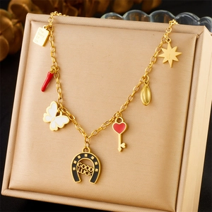 Gold stainless steel charm bracelet featuring engraved plates and colorful charms