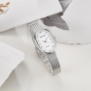 Macro detail of oval dial quartz watch with crystal indices and silver mesh band