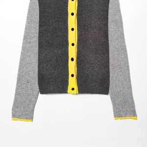 Contrast color knit cardigan with dark grey body, light grey sleeves and yellow trim