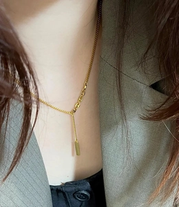 Detail of 18K gold-plated Y-shaped necklace with a minimalist rectangular bar pendant on neck