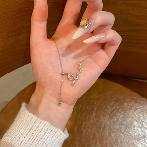 Elegant snake pendant necklace with shimmering zircons and adjustable chain on palm
