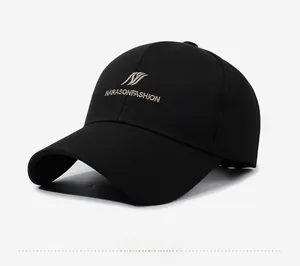 Detail of black baseball cap featuring Narason champagne embroidery on premium cotton