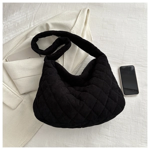 Detail view of black quilted corduroy tote bag showing soft texture and stitching