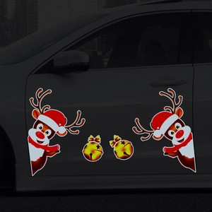 Close-up of reflective Christmas reindeer and gold bell magnetic car door decals