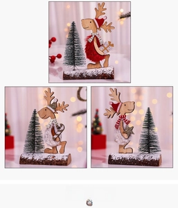 Detail of wooden Christmas cedar trees with reindeer figurines and faux snow base